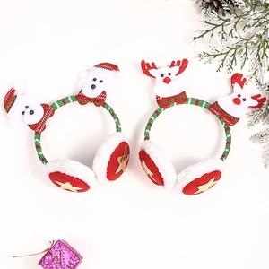 Detail of Christmas earmuffs with plush Santa Claus and reindeer figurines on festive props