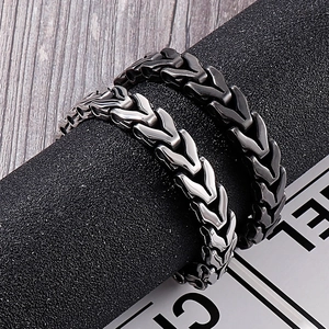 Detail of silver and black stainless steel dragon bone chain bracelets for men