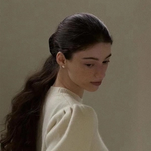 Elegant 5mm round white pearl stud earrings worn by a model in a minimalist style
