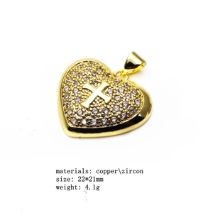 Detail view of gold heart cross pendant with zircon stones, 22x21mm copper jewelry