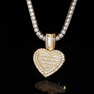 Macro view of gold heart locket pendant with cubic zirconia on a sparkling tennis chain