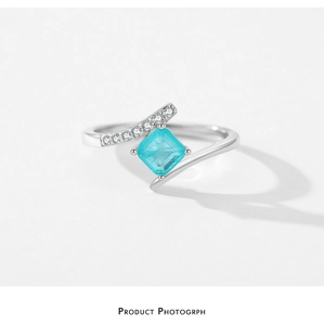 Detail of S925 silver ring featuring a square Paraiba tourmaline and crisscross band