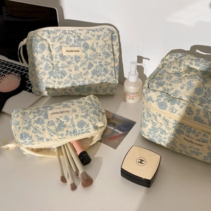 Three-piece quilted cotton floral cosmetic bags in various sizes with blue flower prints
