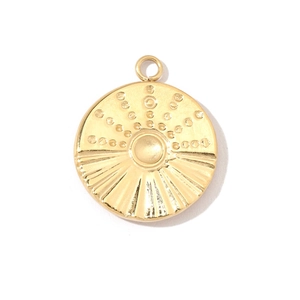 Detailed view of a gold clover compass pendant with sunburst texture in stainless steel