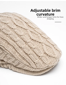 Detail of cable knit texture and foldable wide brim on a warm beige newsboy cap