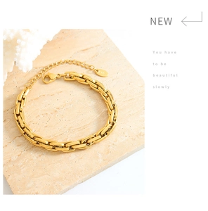 Detail of gold chunky square link chain bracelet with K18 tag and lobster clasp