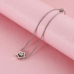 Detail of silver star charm bracelet with cubic zirconia and adjustable pull chain