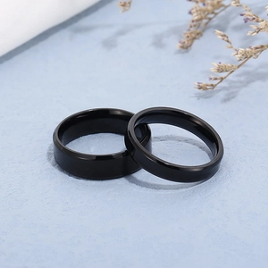 Polished black stainless steel couple rings set with smooth beveled edges for lovers