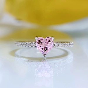 Elegant S925 silver ring featuring a heart-cut pink stone with side diamond accents