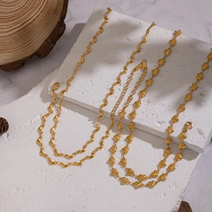 Handcrafted stainless steel gold necklaces with moon and heart link designs on stone