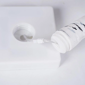 Detail of square white plastic lamp base and connector with birch bark texture