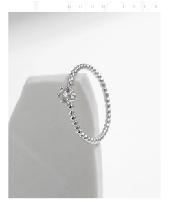 Close-up of s925 silver beaded ring with a brilliant round moissanite in four-prong setting