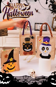 Close-up of Halloween burlap candy bags with pumpkin and skull applique patterns