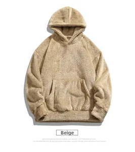 Close-up of beige polar fleece hoodie showing kangaroo pocket and ribbed cuffs texture