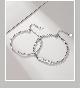 Detailed view of S925 sterling silver bracelets showing bamboo and Cuban chain textures