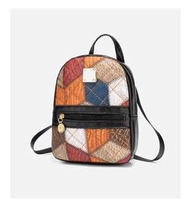 Detail of multi-color leather backpack featuring gold metal buckle and black strap