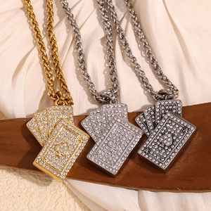 Three playing card necklaces in gold, silver, and gun grey on a dark wood stand