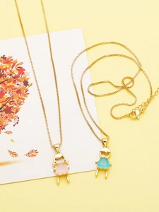 Detailed close-up of boy and girl charms with pink and blue gemstones on gold box chain