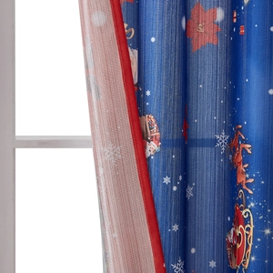 Detail of blue Christmas curtain with Santa and reindeer prints and red border trim