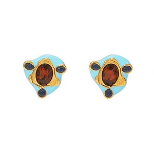 Macro shot of vintage gold earrings with blue enamel and oval reddish-brown zircon stones