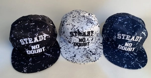 Detail of three snapback hats with marble pattern and STEADY NO DOUBT 3D embroidery