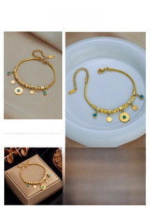 Detail of gold titanium steel bracelet with turquoise charms and adjustable lobster clasp