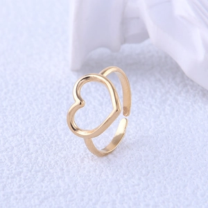Macro shot of minimalist gold heart open ring showing smooth metallic texture and design