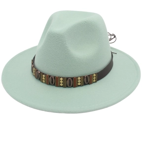 Detailed view of mint green fedora hat with brown leather band and metal seashell ornaments