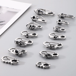 Detail of assorted vintage skull-engraved stainless steel jewelry clasps and buckles