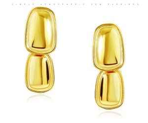 Detailed view of simple atmospheric golden titanium steel double oval geometric earrings
