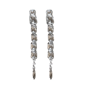 Luxurious silver tassel earrings set with sparkling square crystals on white background