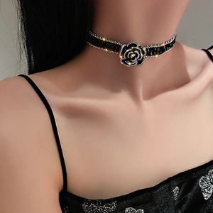 Detailed view of black crystal rose choker necklace with sparkling rhinestones on neck