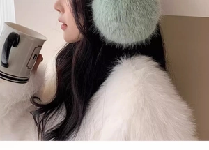 Nahaufnahme weicher mintgrüner Plüsch-Ohrenschützer für Damen im Winter-Look