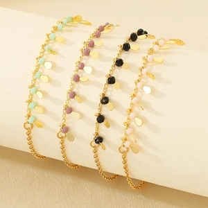 Bohemian gold tassel bracelet with green, pink, and black beads and teardrop pendants