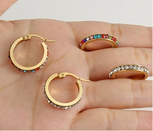 Detailed shot of 18K gold-plated stainless steel hoop earrings with rainbow and clear crystals