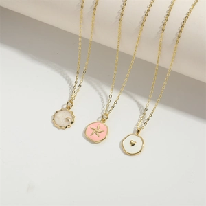 Three elegant gold-plated enamel birthstone necklaces with star and heart symbol charms