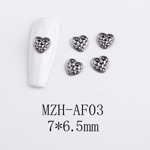 Detail of 7x6.5mm heart-shaped metal nail charms with cross-grid hollow texture