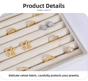 Detailed view of beige velvet jewelry tray with slots for rings and earrings