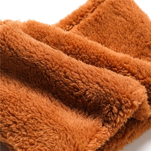 Close-up of soft brown coral fleece fabric texture showing plush and warm material