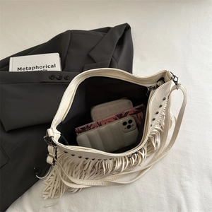 Large capacity cream faux leather hobo bag with tassel and black studs detail