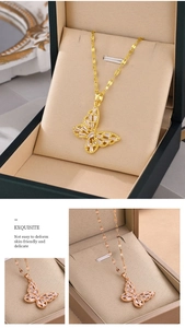 Detailed view of titanium steel butterfly pendants in gold and rose gold with zircons