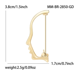 Minimalist gold face silhouette brooch with a small diamond accent and size specs