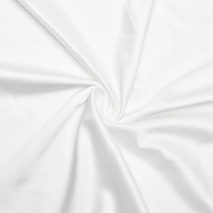 Detail showing the luxurious smooth texture and soft folds of the white silk fabric on the dress