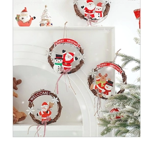 Close-up of rustic Christmas rattan wreaths featuring Santa and Snowman on a white mantle
