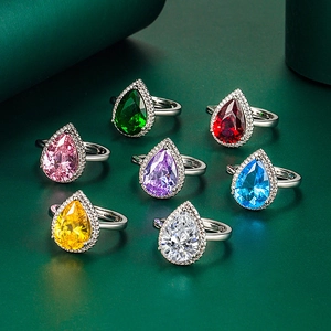 Detail of seven silver teardrop rings with vibrant multicolored pear-cut gemstones