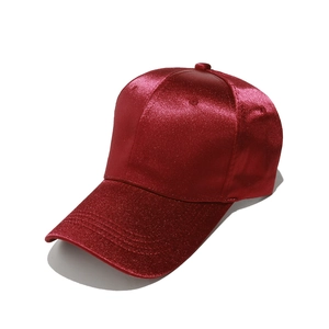Detailed close-up of dark red satin texture and glitter finish on the baseball cap