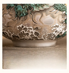 Detail of the finely polished ceramic tea cup base with traditional blue dragon pattern