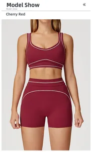 Detail of high-waist cherry red yoga shorts with contrasting white piping for fitness