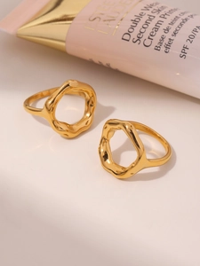 Detail of 18K gold plated stainless steel rings with irregular lava texture design