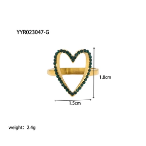 Dettaglio anello a cuore dorato con pietre verdi e indicazione delle misure esatte